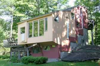 The exterior new cedar siding was stained with two colors delineating the private rooms from the common areas inside.