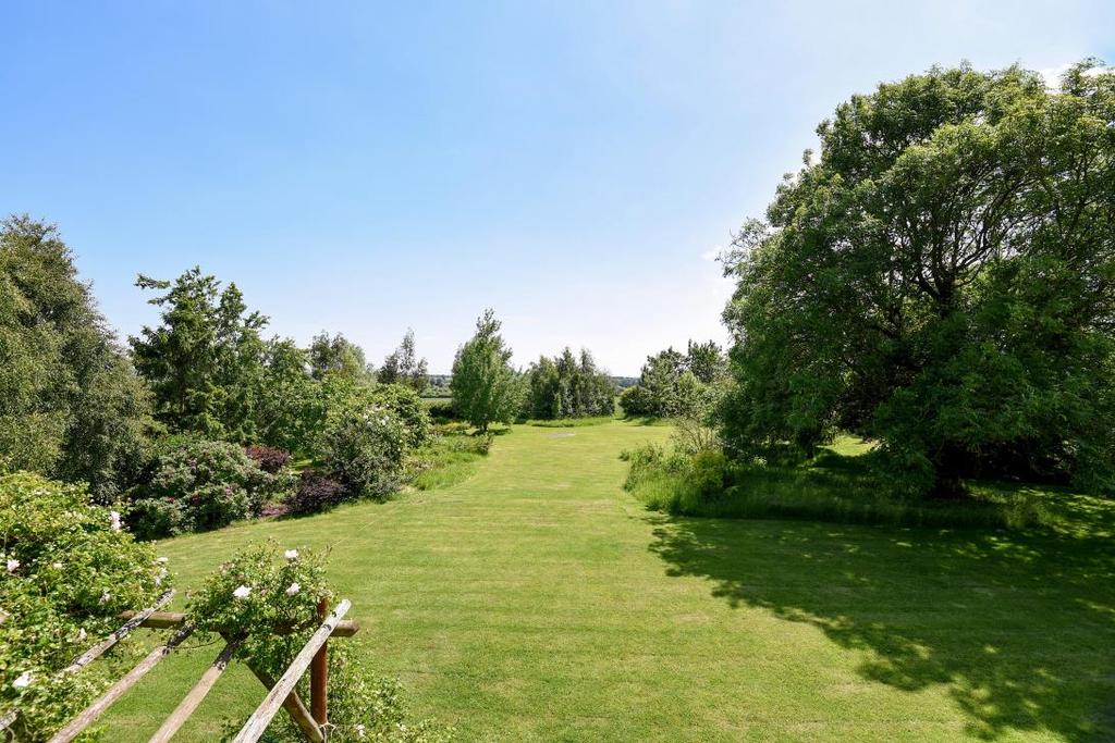 The beautiful mature gardens surround the house and are stocked with an exceptional range of plants and shrubs including lilac, hydrangea, daffodils, numerous roses as well as a wide variety of
