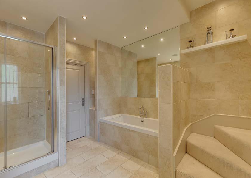 To one corner, there s a separate shower enclosure with a fitted Mira shower and a glazed screen/door.