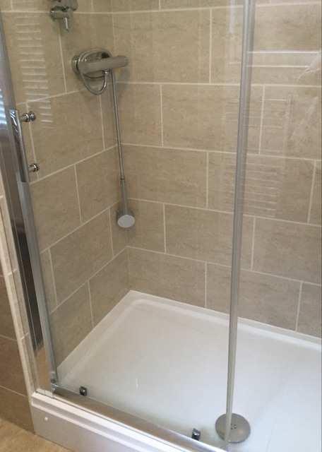 Screw caps to the front with chrome handle, easily slides with a white shower tray, with a long chrome shower waste and plug.