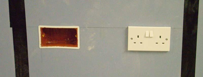 a) a) Socket boxes with putty on the source room side of the partition b) Socket boxes with putty on the receiving room side of the partition b) Figure 3 A view of the partition section showing four