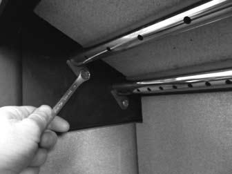They are not fixed with any fixings. The one upper baffle is held in place by a bracket at the rear and a bracket at the front top, being trapped between the two brackets.