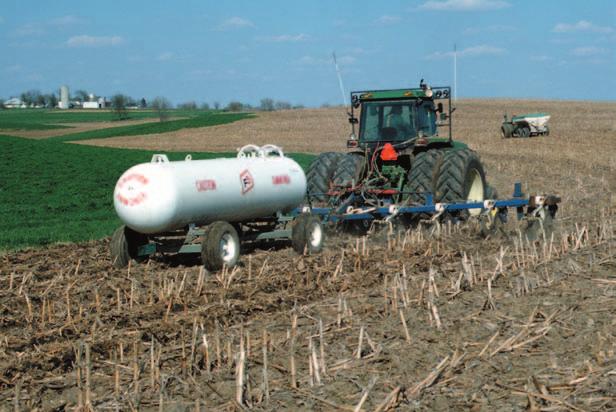 Figure 3.21. This implement is applying anhydrous ammonia on a field with corn residue cover. The white tank ( nurse tank ) contains ammonia under pressure. Photo provided by USDA-NRCS.