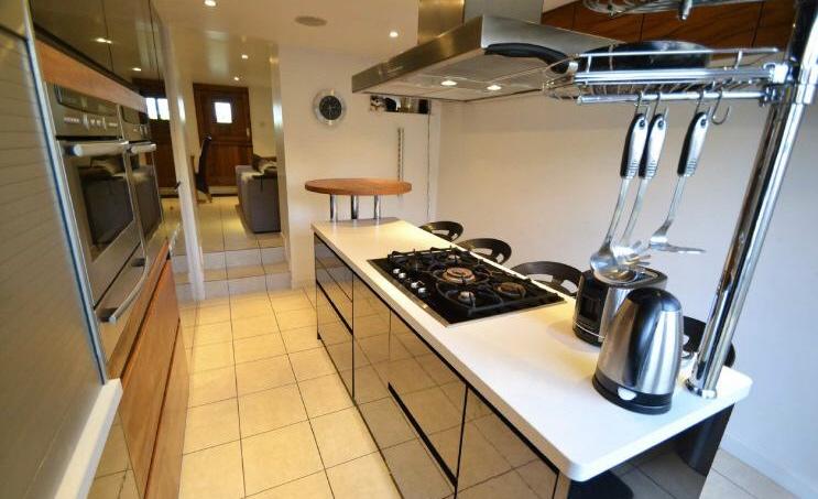 There is a spacious open plan lounge / diner with inset working fireplace, plenty of storage under the stairs and an opening to the new modern kitchen with secret shower room and double doors to the