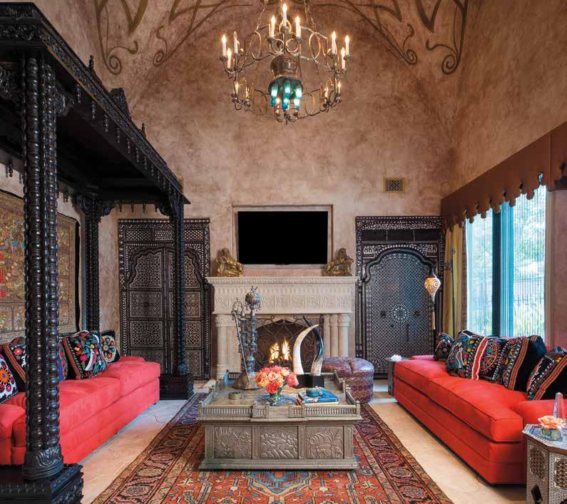 Opposite: A custom rug from Interior Resources runs up the staircase. Painting by John Douglas. Antique chandelier from France. brass and bronze light fixtures from AOI Home.