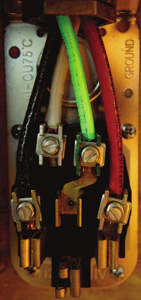 This picture shows the circuit wires terminating to a 14-50R outlet receptacle, with the protective cover removed.