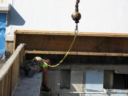 Construction worker using crane