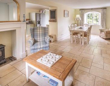 The hand-built kitchen has a good range of built-in cupboards, granite work surfaces and integral appliances including a dishwasher, American style fridge freezer with ice maker, washing