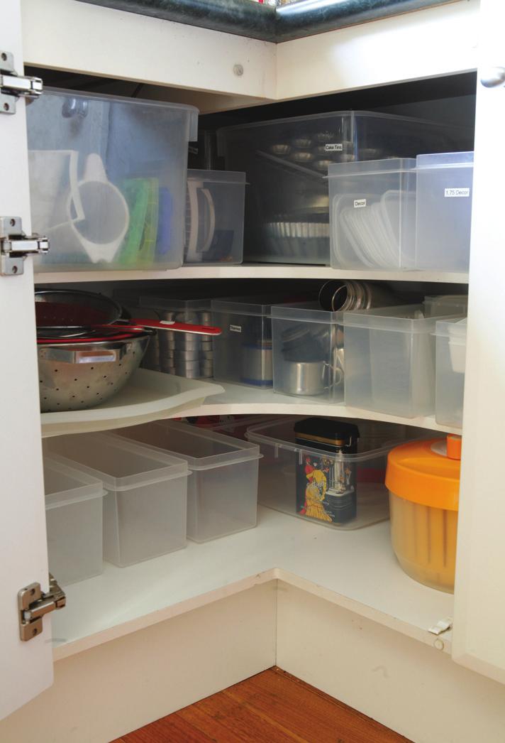 From Stuffed to Sorted containers along one back wall of the cupboard so that the container closest to the door opening slides out easily and freely.