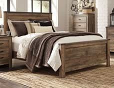 B446 Trinell Vintage casual group in warm rustic plank finish over replicated oak grain Authentic touch technology adds to the authenticity of the rustic appearance Features faux metal bands with