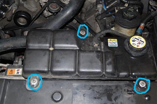 2. Once the radiator has drained, remove the three, 11mm nuts holding the