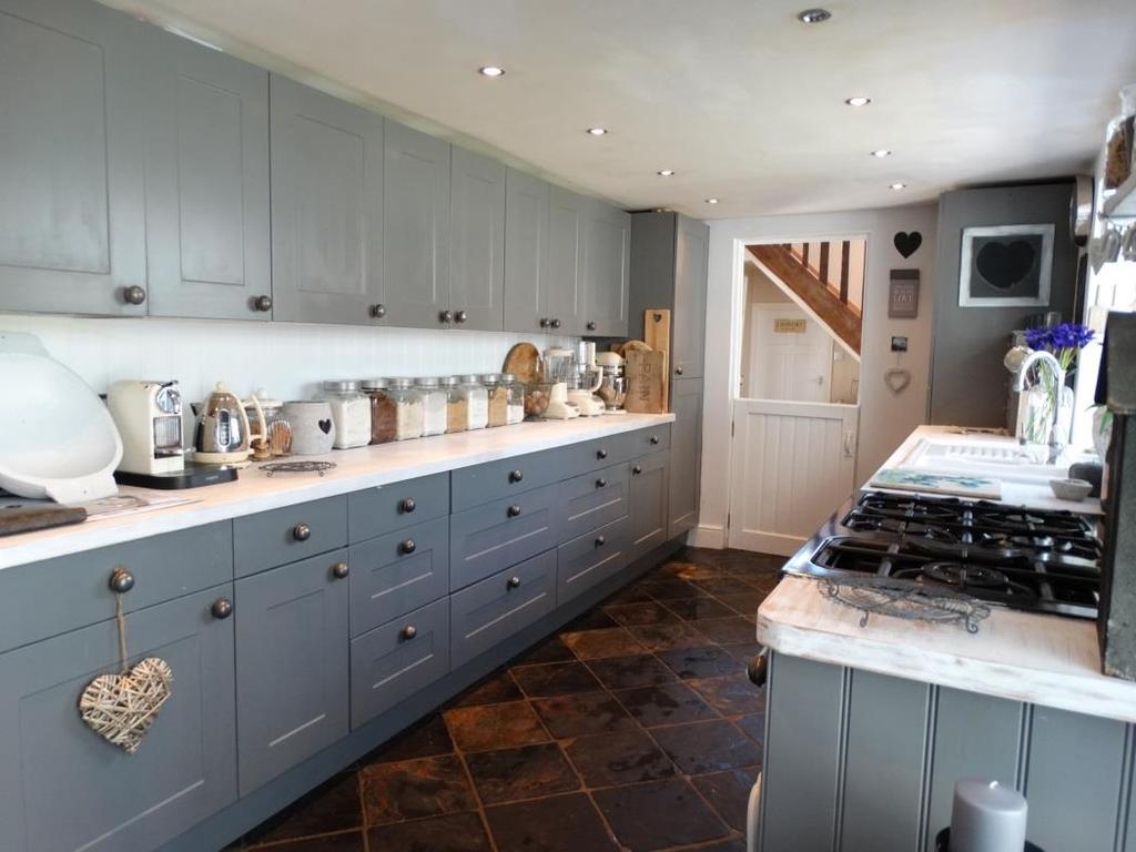 KITCHEN 18 7 x 8 4. Overlooking conservatory. Fitted with traditional slate flooring. Base and eye level units incorporating a ceramic 1½ bowl sink unit with mixer tap and Rangemaster.