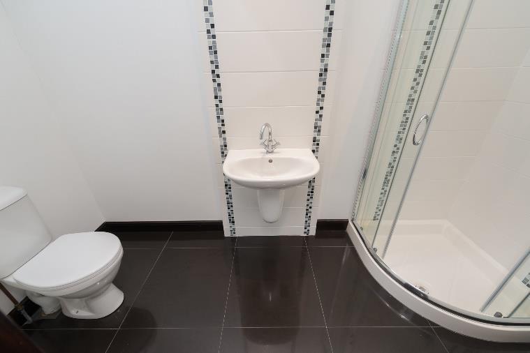 75m (5 9 x 5 9 ) White suite comprising pedestal wash hand basin, low flush W.C and corner shower unit with thermostatic shower, extractor fan. Ceramic tiled floor and part tiled walls. Bedroom 4 4.