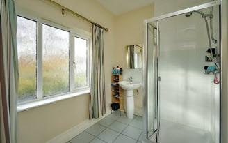 tiled built-in shower cubicle with shower unit,
