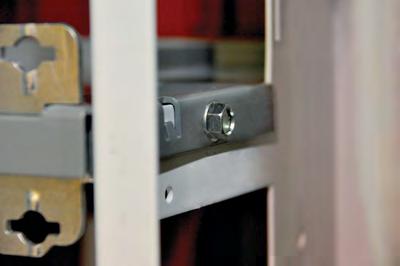 retaining-clip through the holes in the vertical wireway wall and pan, work from inside the vertical wireway as shown.