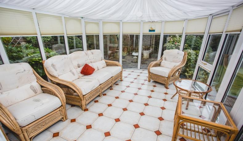 Attractive Conservatory: 12/0 x 10/0 with ceramic tiled floor and central heating radiator, double door access to raised timber deck area within a private landscaped