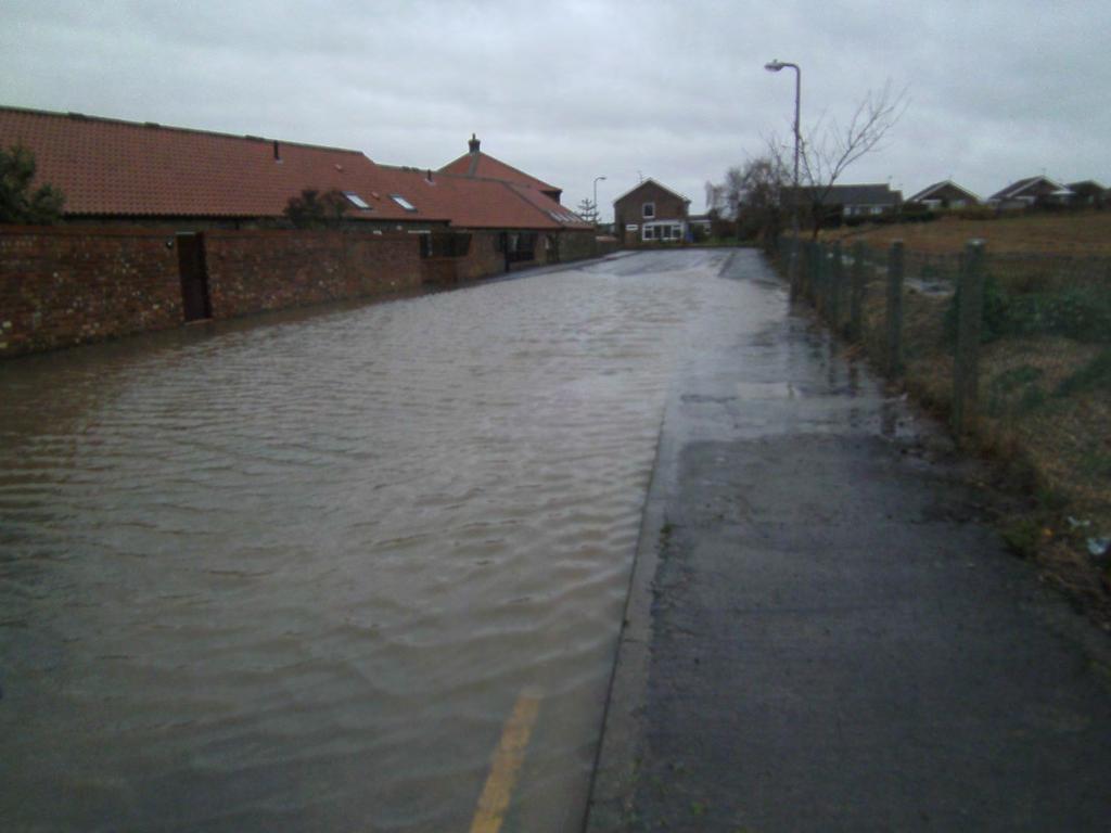 PHOTOGRAPH OF FLOODING ALONG THE CHURCH CLFF DRIVE Photograph