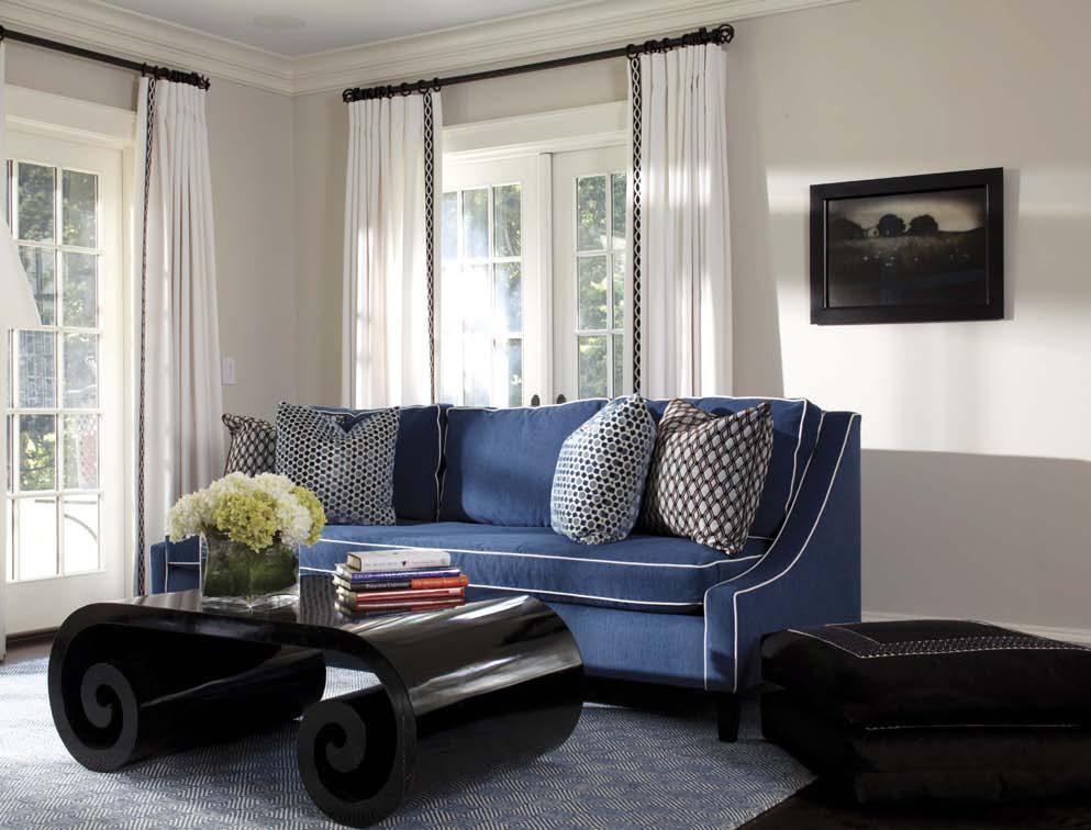 design In the family room, crisp white and deep blue accents mingle nicely with club chairs sporting zebra patterned upholstery.