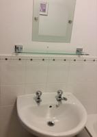 The painted decor and bathroom tiling are clean and in good condition.