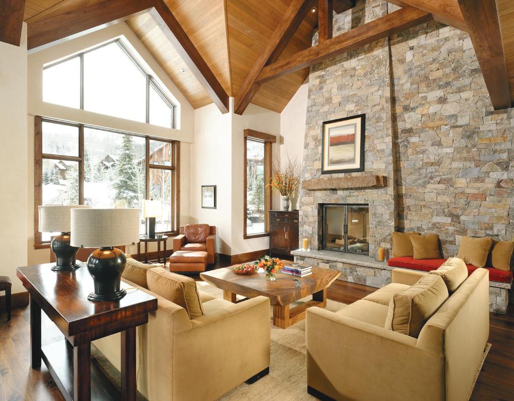 ABOVE: The stone fireplace is a grand centerpiece for this room. Alder beams accentuate the opulent space and contrast with the smoked European Beech ceiling; something of a rarity.