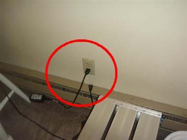 It is not recommended that outlets be installed in this manner as the cords of plugged in devices will hang in front of the heater.