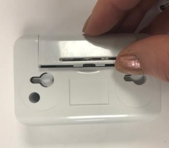 Remove the battery cover, lifting the cover up from the centre of the Sensor.