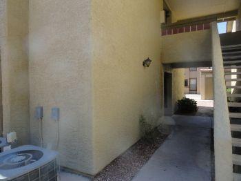 Stucco was stained near the front entrance due to a dripping secondary air conditioner condensation line.