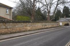 Stone walls of Warneford Hospital in Roosevelt Drive Community Assets The mature wooded