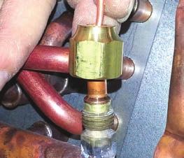 Inspect the TXV box to confirm that the valve is compatible with the refrigerant in the system. A. Remove the valve stem from the Schrader port mounted on the suction line. B.