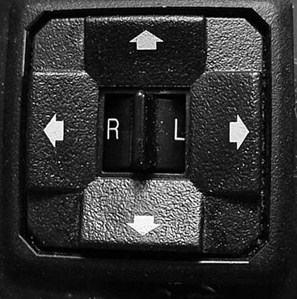 The electric mirrors are adjusted using a multi-directional switch located on the driver s door panel to the left of the steering wheel. Move L or R to select mirror, or center for neutral.
