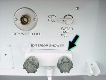 SECTION 7 PLUMBING SYSTEMS NOTE: The dump valve spout can be swiveled downward or upward for routing the hose out the bottom hatch while connected to on-site waste disposal, or out the side door when