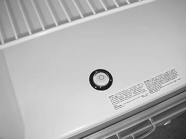 A small round bubble level is provided with your refrigerator.