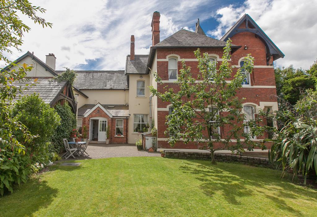 1877, set back from Belmont Road and recognisable by its distinctive turret, the house is surrounded by totally private mature gardens and is a charming home with an immediate at home feeling.
