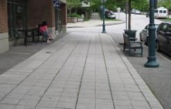 features: a. Walking surfaces with attractive pavers b. Area for commercial display or activities c.