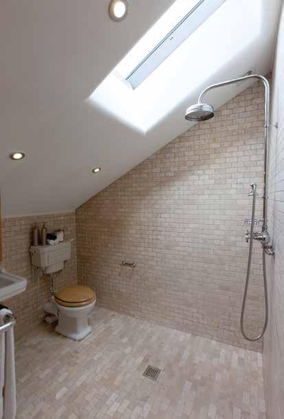 There is a chrome rain head shower and hand shower attachment, Velux