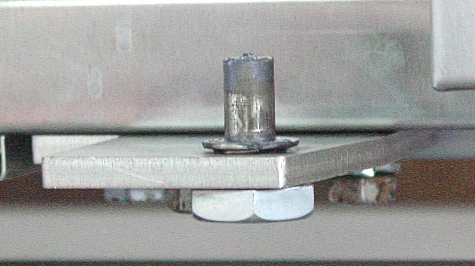 23) Align the top hinge plate fitted to the door, with the screw holes at the top of the oven and secure the top hinge plate to the top of the oven.