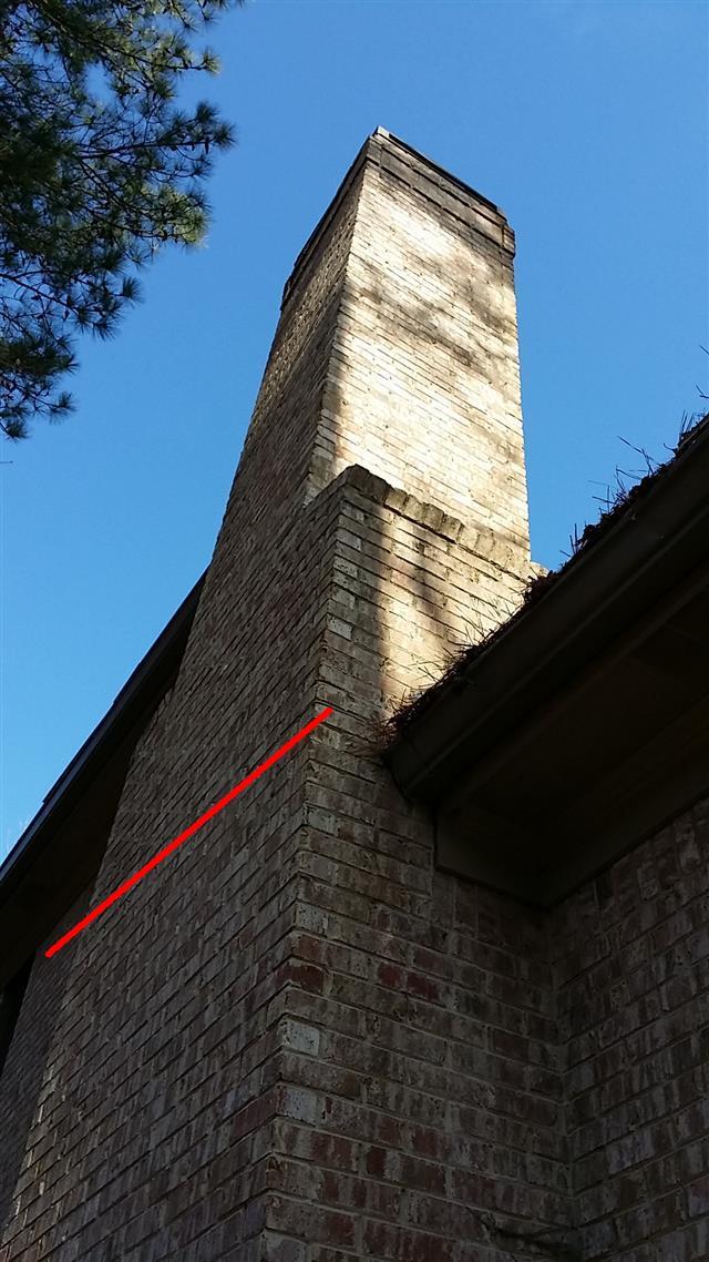There is a crack in the brick veneer near the gutter line that extends the full width of the chimney. This is a potential safety issue that should be corrected.