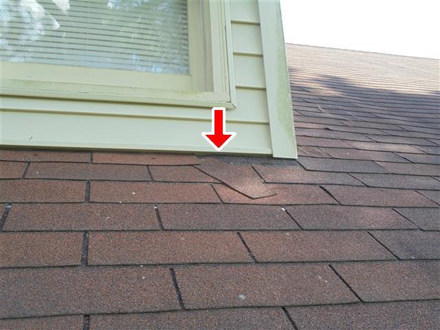 I. STRUCTURAL SYSTEMS D. Item 1(Picture) Loose shingle under the dormer D. Item 2(Picture) Shingles at the carport D.