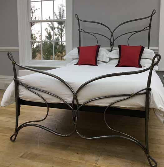 iron bed with a trellis effect and feminine curved shaping on the headboard and footboard Code: