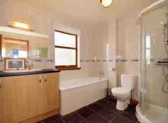 unit. There is pine flooring, shaver socket, a radiator, ceiling lighting and wall lights. Shower room 1.86m x 1.