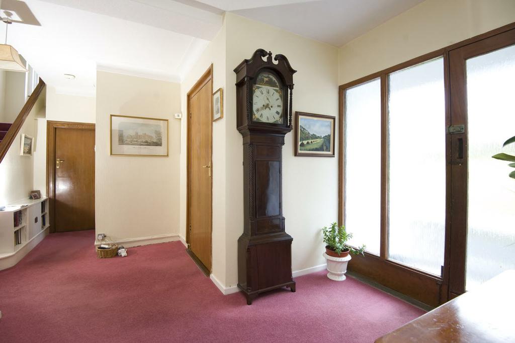 The Property Comprises: COVERED ENTRANCE PORCH: Glazed front door and sidelights.