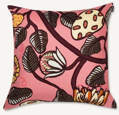 Decorative cushion cover for bed in coral pink room.