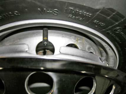 The wheel on your coach has a push on liner which is removed similar to a hubcap. Remove the covers by carefully prying the perimeter flange away from the wheel flange.