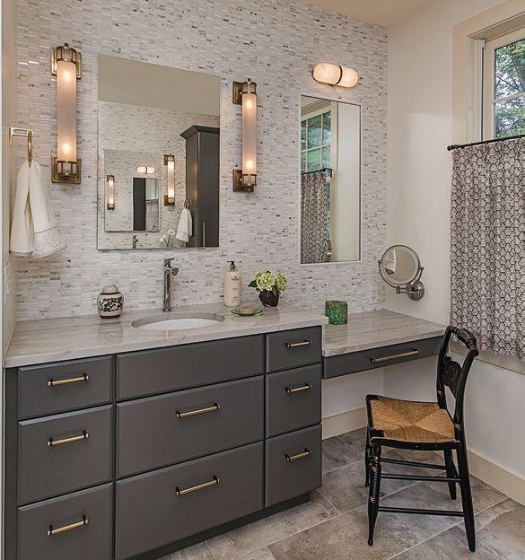 THE RIGHT INGREDIENTS Her side of the renovated master bath positions an heirloom chair in front of a vanity with a recessed mirror below a sconce from Kelly
