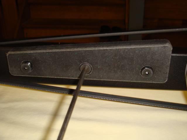 An older design used three screws; the latest belt guards feature a cutout for