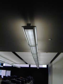 These fluorescent fixtures are suspended between the acoustic ceiling panels, which are suspended from the concrete ceiling (Figure 5).