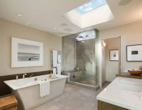 The gracious spa-like master bathroom includes a generous skylight, a