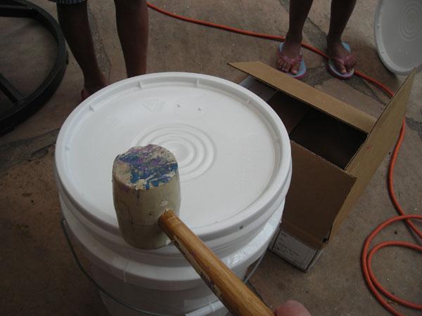 Use a rubber mallet to seat the bucket lid.