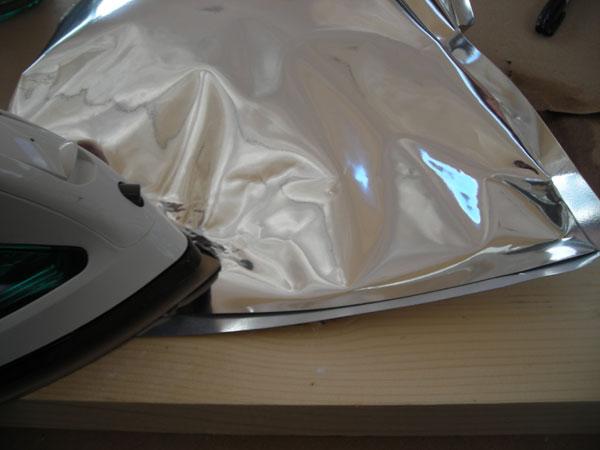 Shake the bag to settle the material. Carefully fold the excess Mylar over so that you can lay the bag on your work surface.