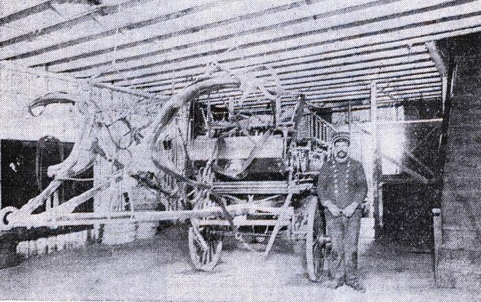 1904 John Gill poses beside the hook and ladder fire truck he drove in about 1904.